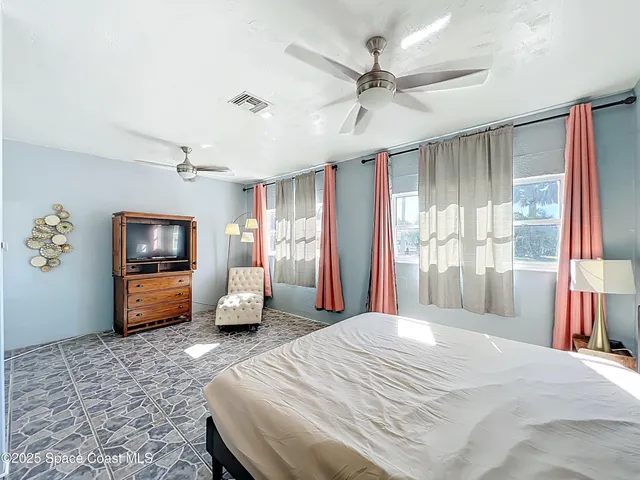 a bedroom with a bed and a couch