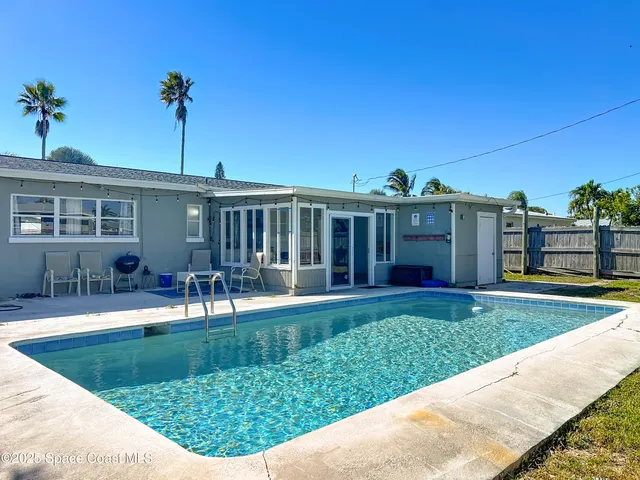 a view of swimming pool with outdoor seating and yard