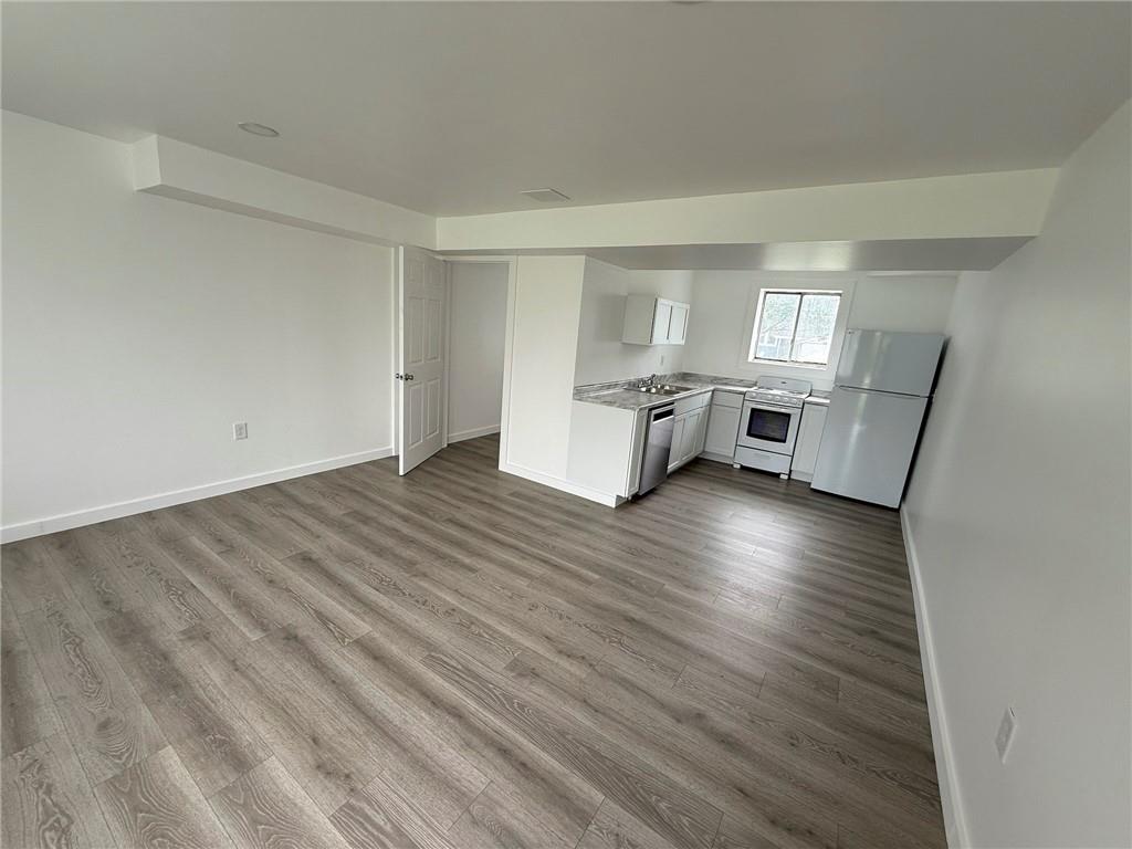 216 East Jackson Street Houston, PA 15342 - Photo 2 of 14 an empty room with wooden floor and window