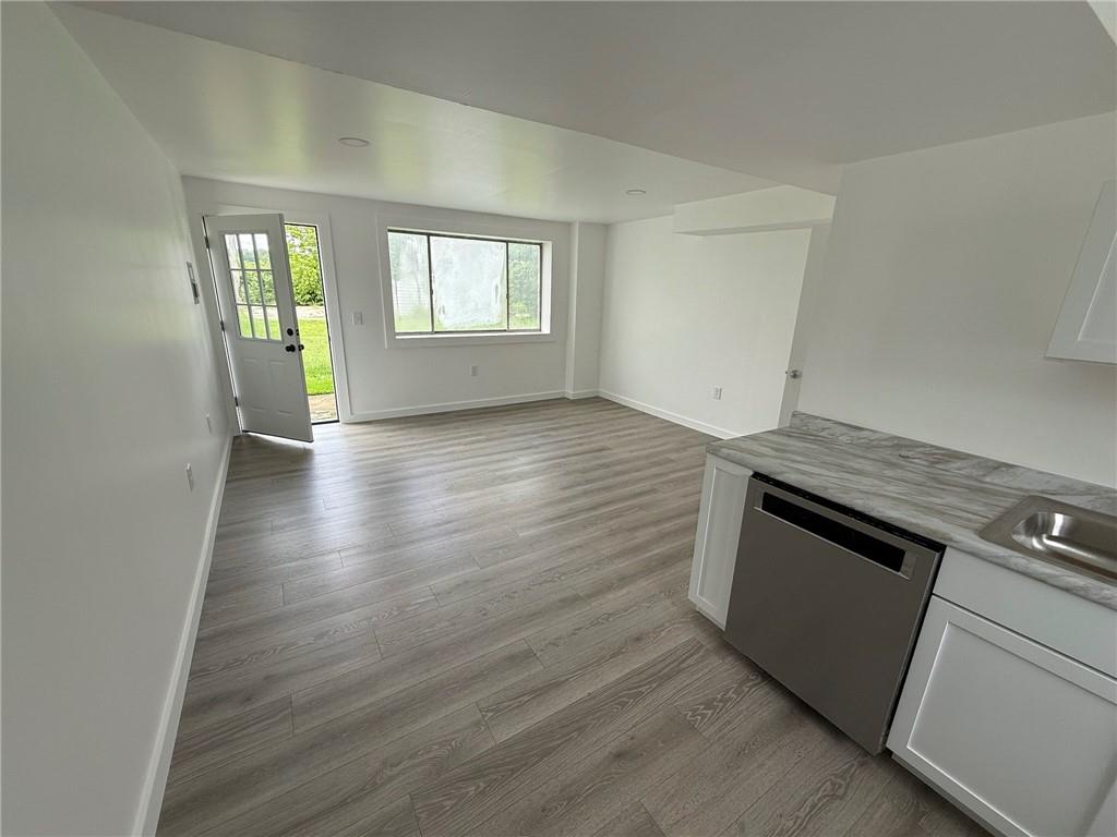 216 East Jackson Street Houston, PA 15342 - Photo 3 of 14 an empty room with wooden floor and windows