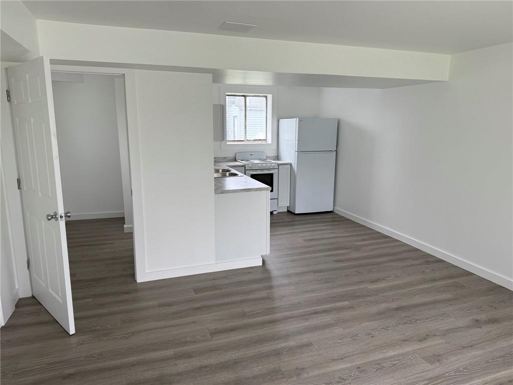 216 East Jackson Street Houston, PA 15342 - Photo 4 of 14 a view of a kitchen with wooden floor and a hallway