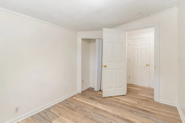 a view of an empty room and wooden floor