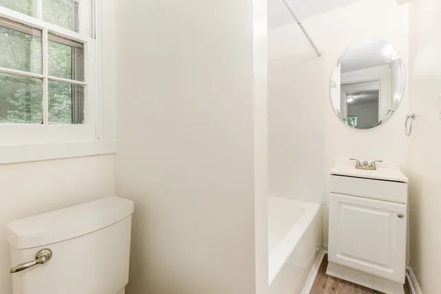 a bathroom with a toilet sink and vanity