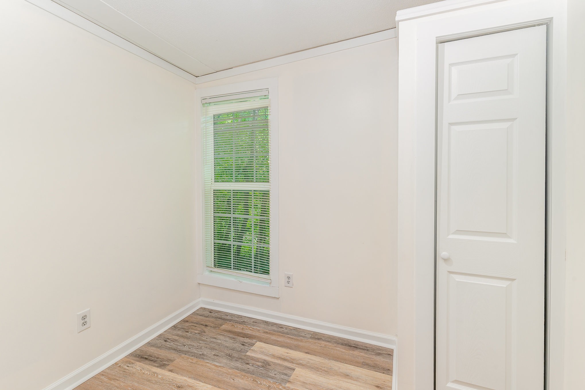 1018 Bridge Street Columbia, TN 38401 - Photo 14 of 18 a view of an empty room with wooden floor and a window