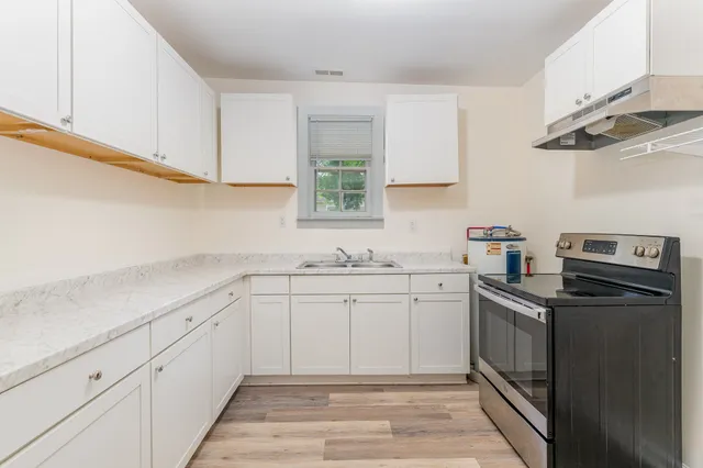 a kitchen with a sink dishwasher and cabinets