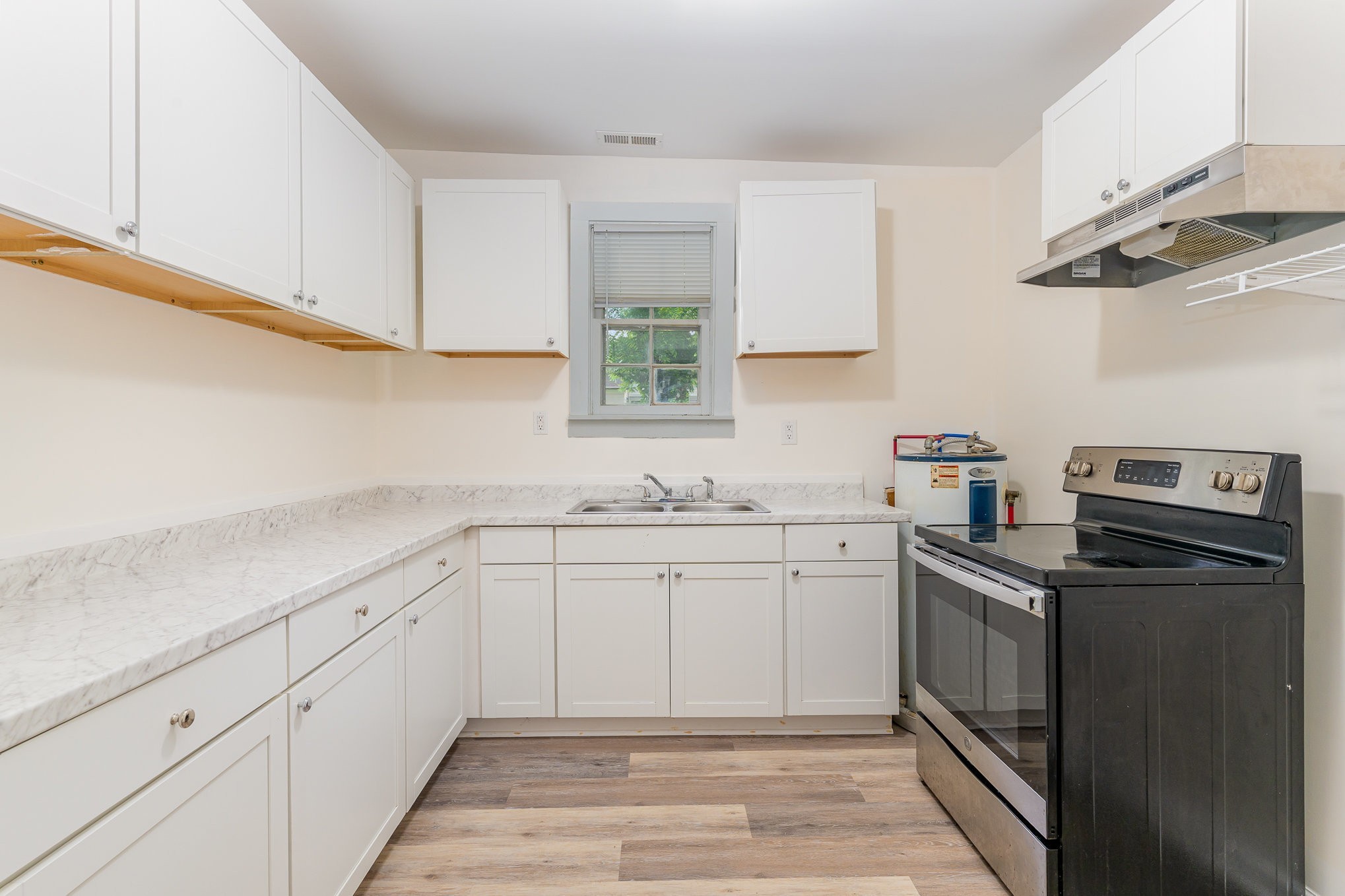1018 Bridge Street Columbia, TN 38401 - Photo 4 of 18 a kitchen with a sink dishwasher and cabinets