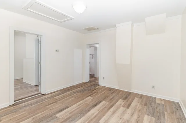 a view of a room with wooden floor