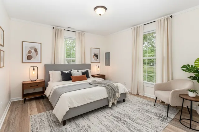 a bedroom with a bed and windows