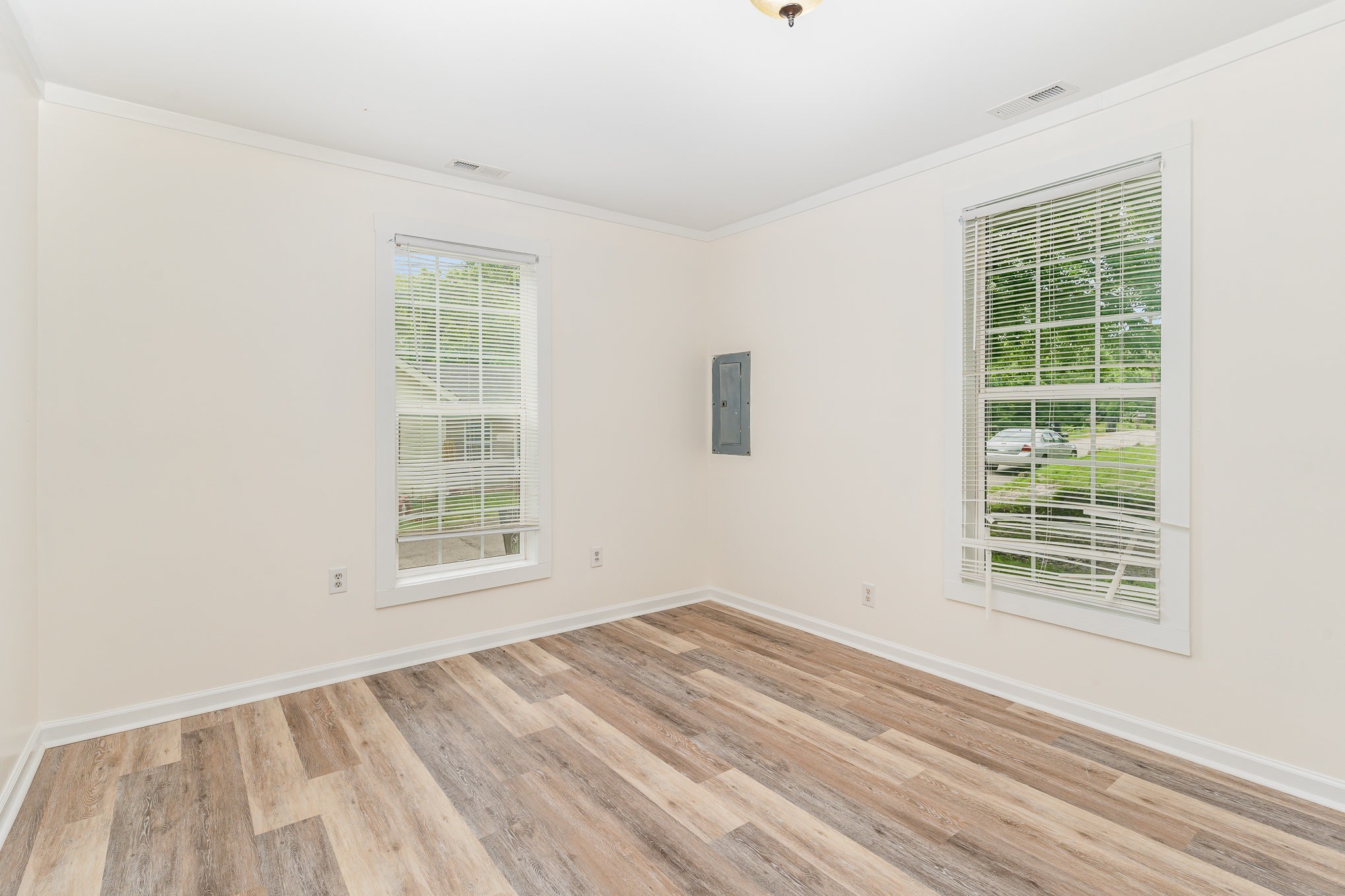 1018 Bridge Street Columbia, TN 38401 - Photo 10 of 18 an empty room with wooden floor and windows