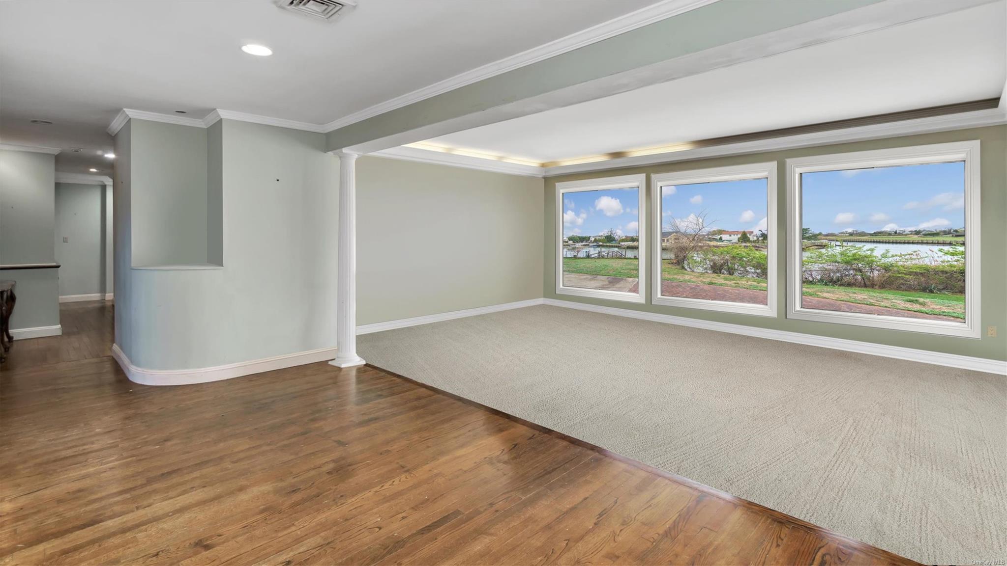 1230 Harbor Road Hewlett, NY 11557 - Photo 11 of 27 a view of an empty room with wooden floor and a window