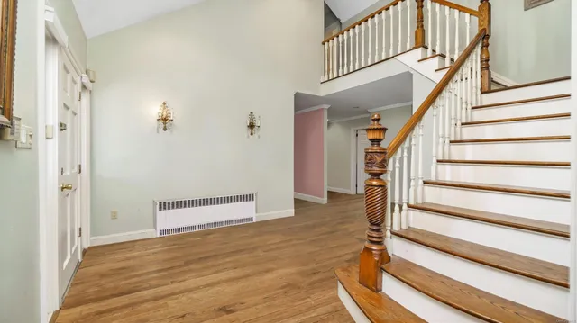 a view of entryway with wooden floor and stairs