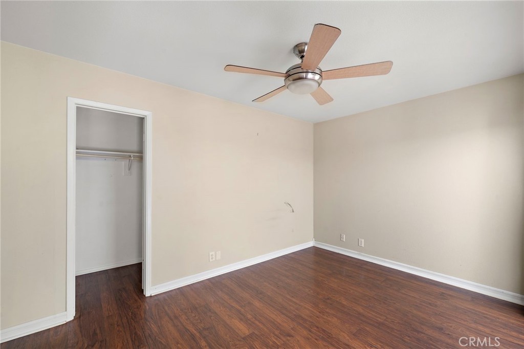 14272 Raintree Road Tustin, CA 92780 - Photo 11 of 24 an empty room with wooden floor and ceiling fan