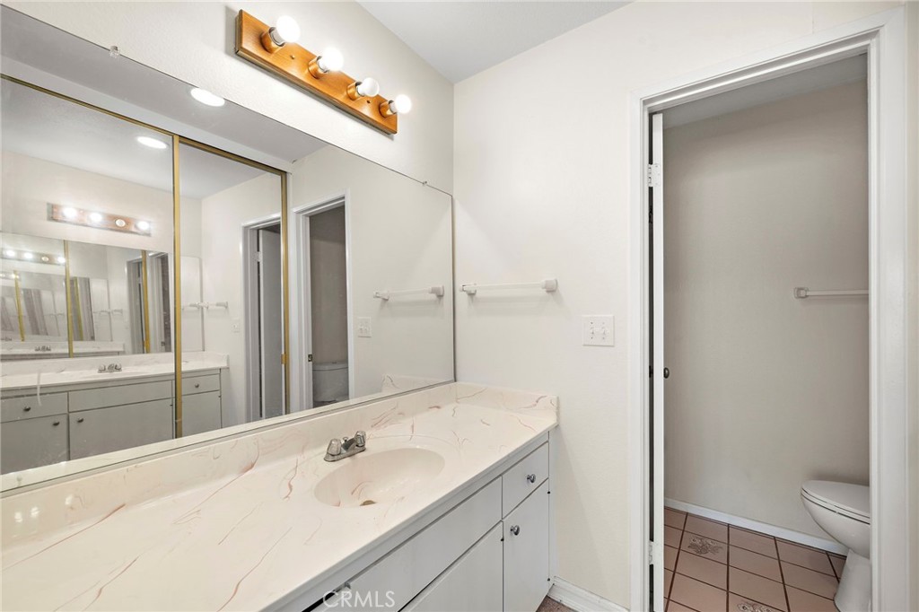 14272 Raintree Road Tustin, CA 92780 - Photo 12 of 24 a bathroom with a sink a toilet and shower