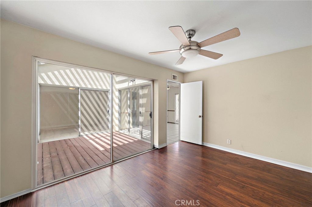 14272 Raintree Road Tustin, CA 92780 - Photo 10 of 24 a view of an empty room with wooden floor and a window