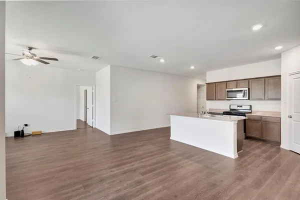 a view of kitchen with cabinets and wooden floor