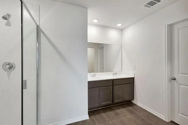 a bathroom with a double vanity sink a and mirror