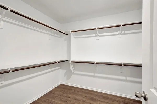 a view of walk in closet with empty racks