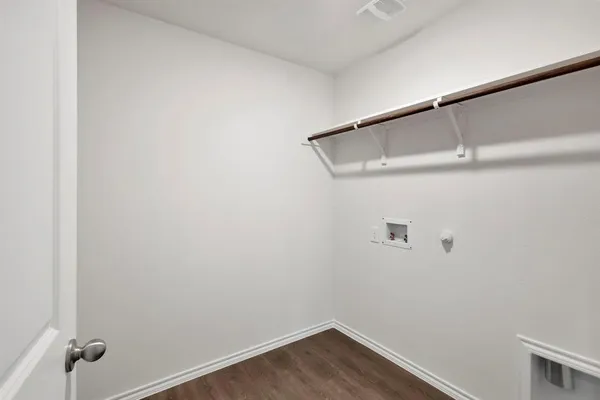 a view of a room with wooden floor