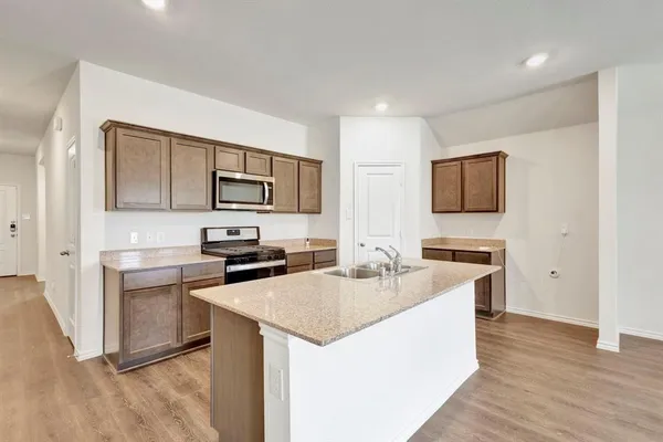 a kitchen with a sink microwave and refrigerator