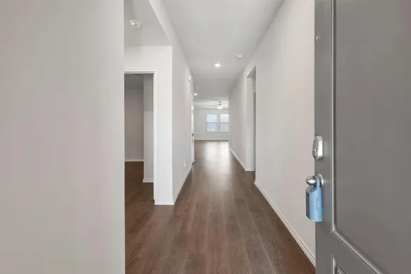 a view of a hallway with wooden floor