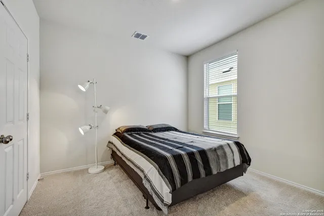 a bedroom with a bed and window