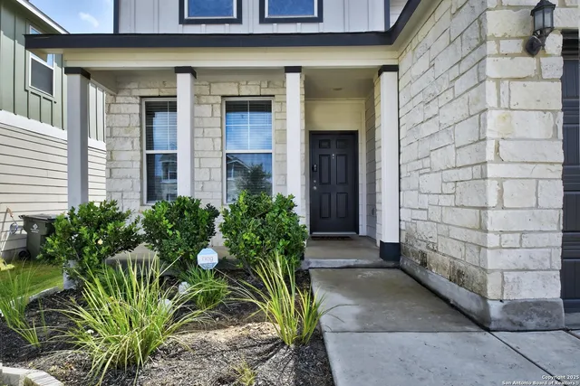 a view of a brick house with plants
