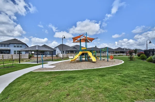 a view of a house with swimming pool and a yard