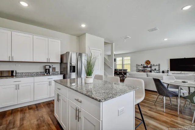 a kitchen with center island table and chairs