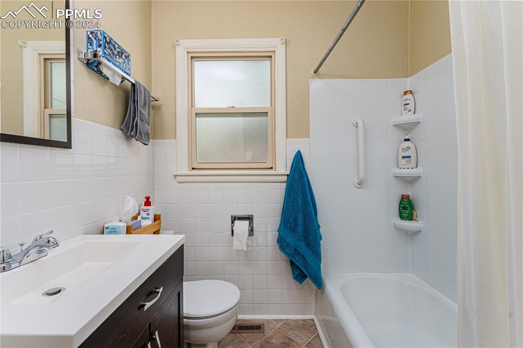 1002 Alexander Road Colorado Springs, CO 80909 - Photo 16 of 28 a bathroom with a sink toilet and shower
