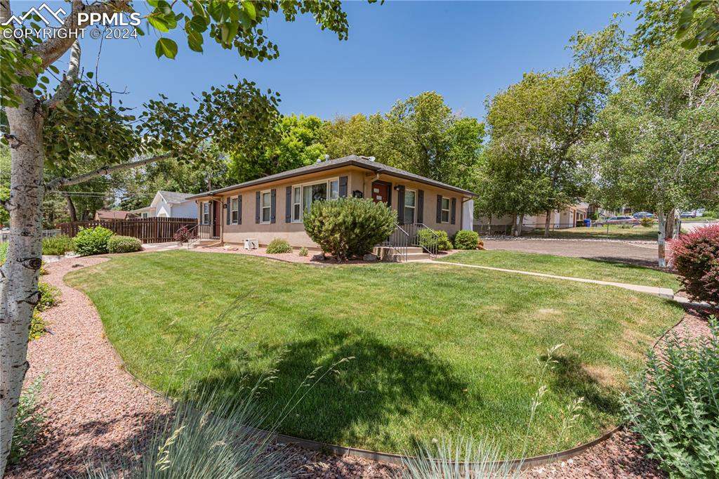 1002 Alexander Road Colorado Springs, CO 80909 - Photo 27 of 28 a view of a house with a yard porch and sitting area