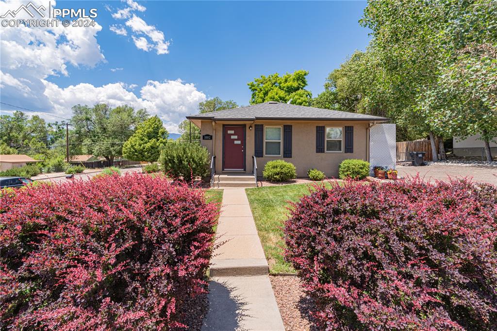 1002 Alexander Road Colorado Springs, CO 80909 - Photo 6 of 28 a view of a house with a garden