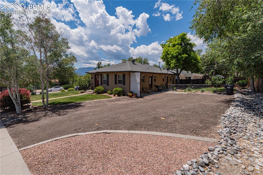 1002 Alexander Road Colorado Springs, CO 80909 - Photo 10 of 28 a view of a house with a yard