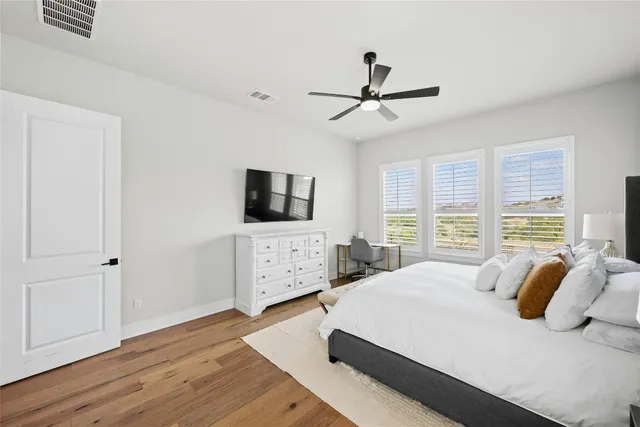 a bedroom with a bed a couch and a window