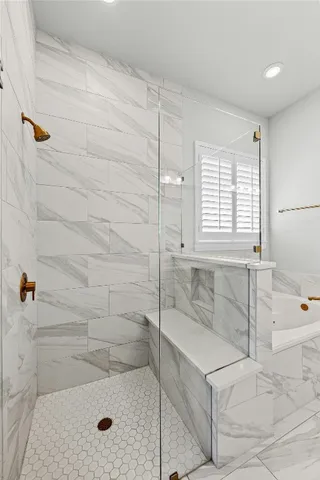 a bathroom with a tub sink and a mirror