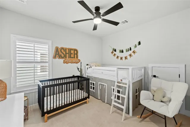 a bedroom with furniture and a flat screen tv