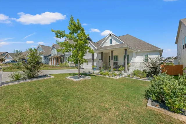 a front view of a house with a garden