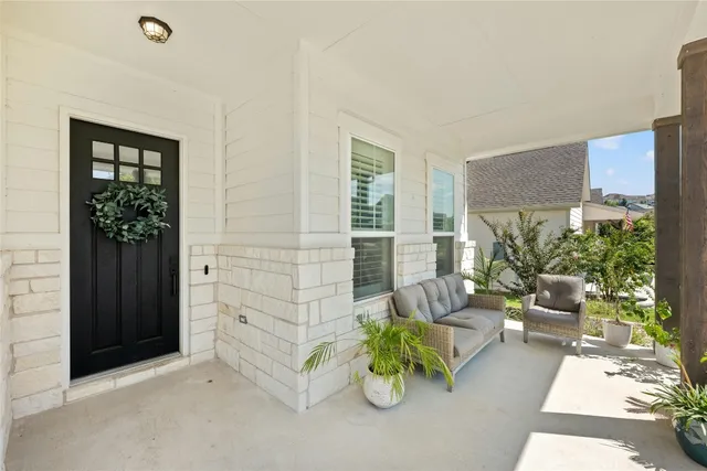 wooden floor view of living room filled with furniture and a potted plant