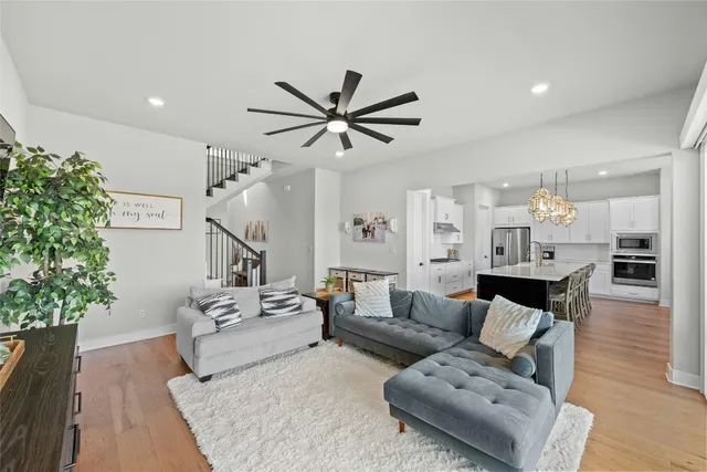 a living room with furniture and a chandelier