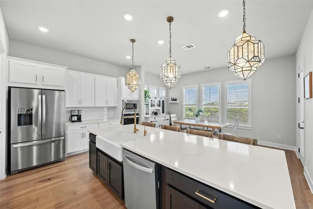 a large kitchen with a table and chairs