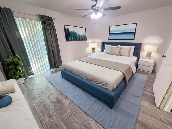 a bedroom with bed and a painting on the wall