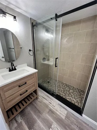 a bathroom with a shower and a mirror