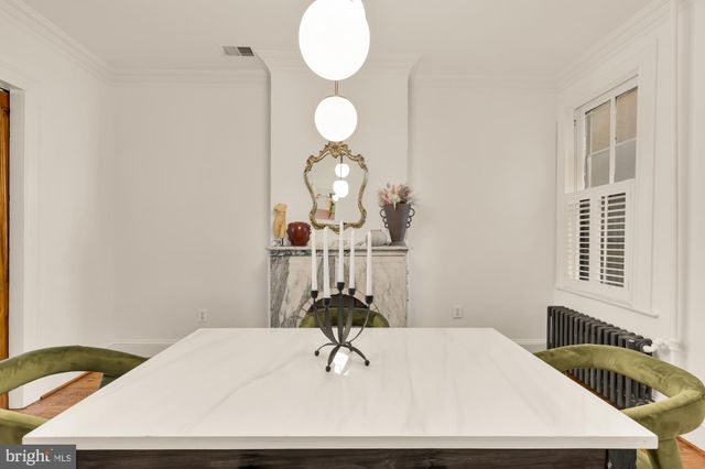 a view of a dining room with a table and chairs