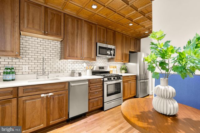 a kitchen with sink and cabinets