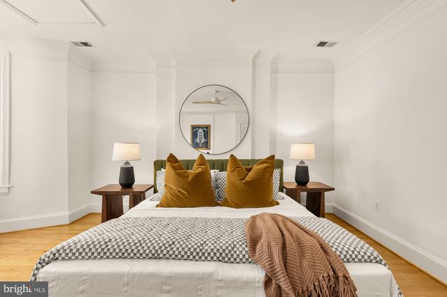 a bedroom with a bed and a potted plant