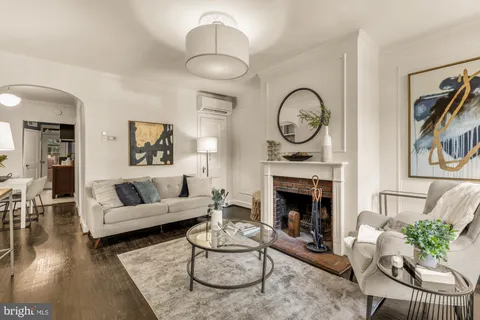 a living room with furniture fireplace and a fireplace