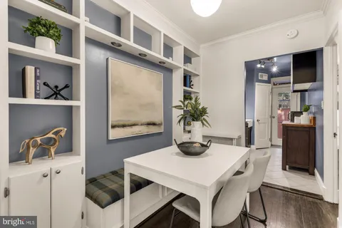 a dining room with furniture and window