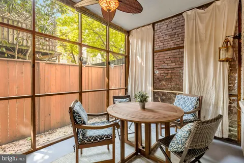 a view of a dining room with furniture and a window