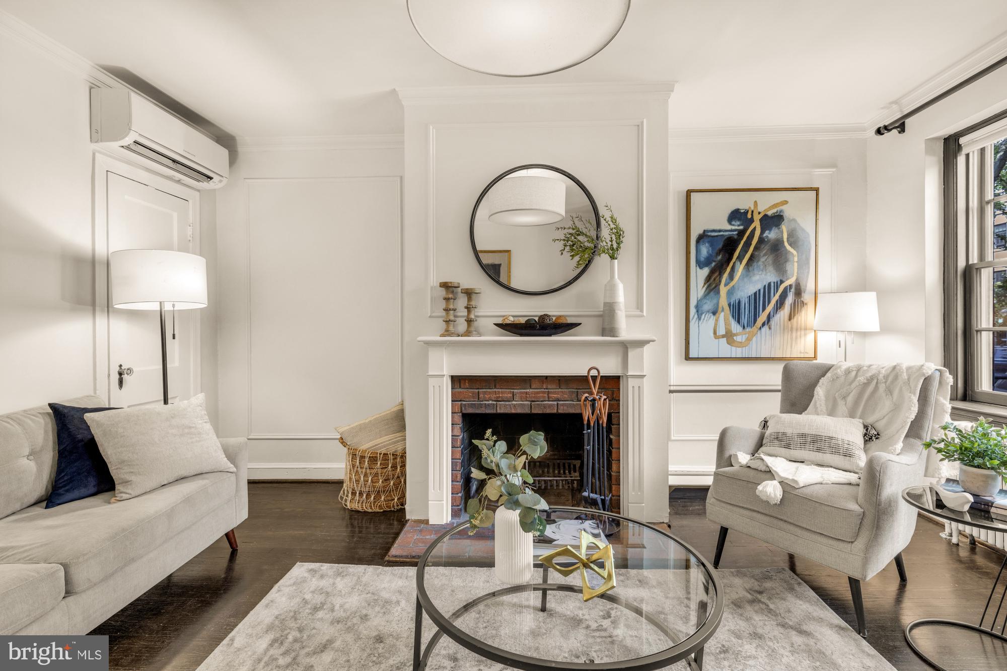 1127 C Street Southeast, Unit 2 Washington, DC 20003 - Photo 6 of 17 a living room with furniture and a fireplace