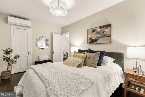 a bedroom with bed and a potted plant