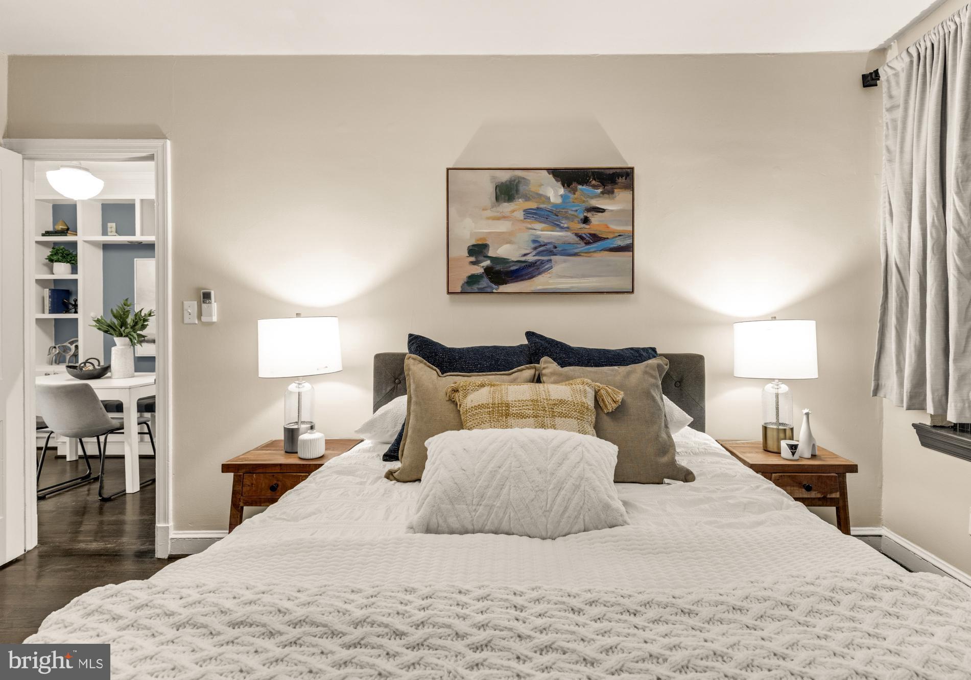 1127 C Street Southeast, Unit 2 Washington, DC 20003 - Photo 8 of 17 a bedroom with a large bed and a chandelier